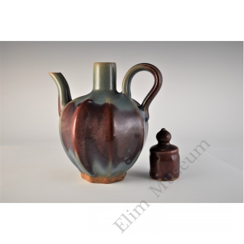 1711 A stoneware lidded ewer in lavenda blue glaze and purple splashes    