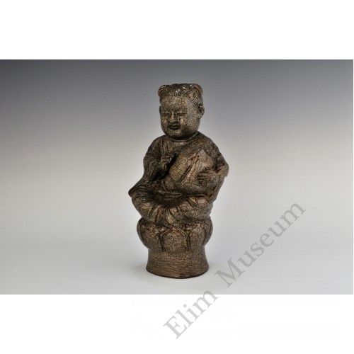 1724  A Yue-ware hand-scupted "peach boy"  seated on lotus
