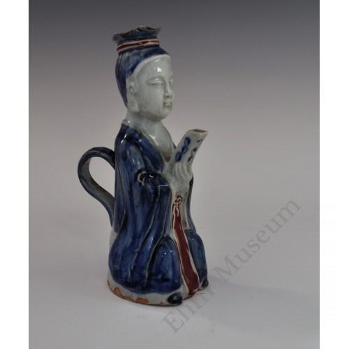 1730   A figure shaped porcelain ewer decorated by under glaze blue and red      